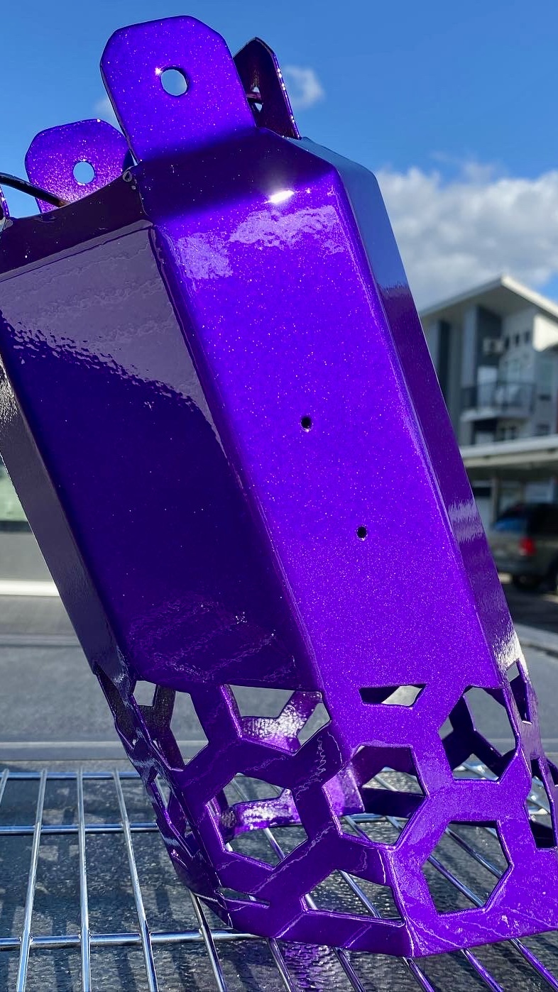 Custom purple powder coated exhaust tip with a high-gloss finish